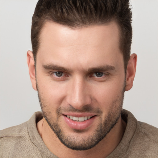 Joyful white young-adult male with short  brown hair and brown eyes