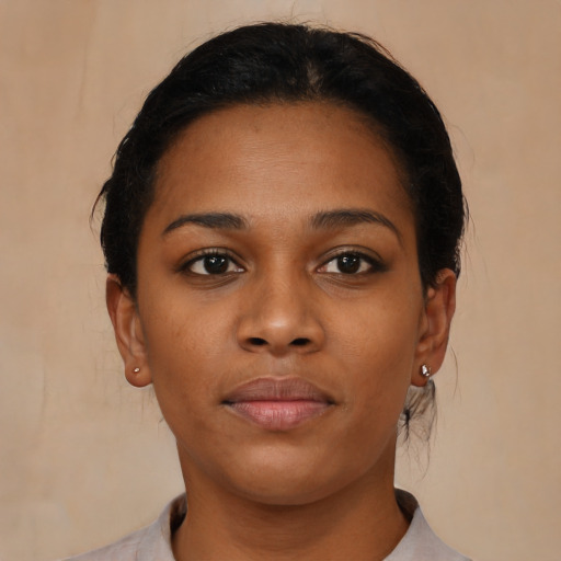 Joyful black young-adult female with short  brown hair and brown eyes