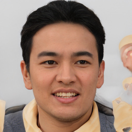 Joyful asian young-adult male with short  brown hair and brown eyes
