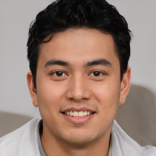 Joyful asian young-adult male with short  brown hair and brown eyes