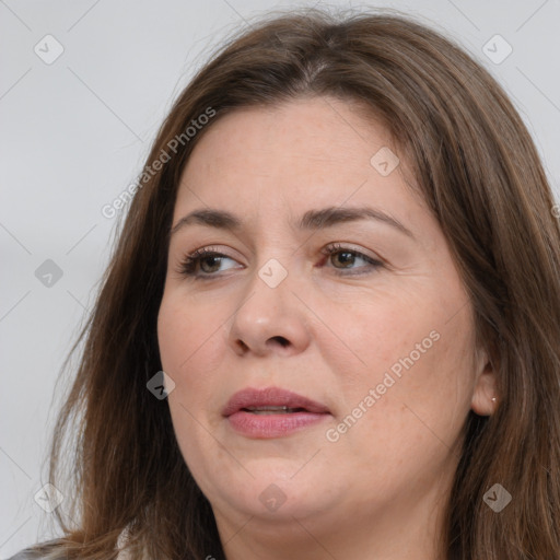 Joyful white adult female with long  brown hair and brown eyes