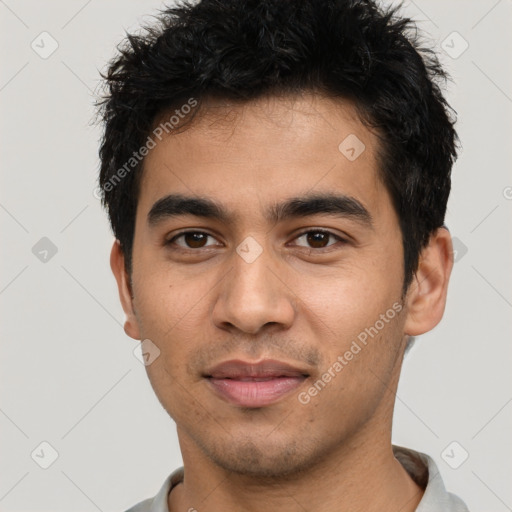 Joyful latino young-adult male with short  black hair and brown eyes