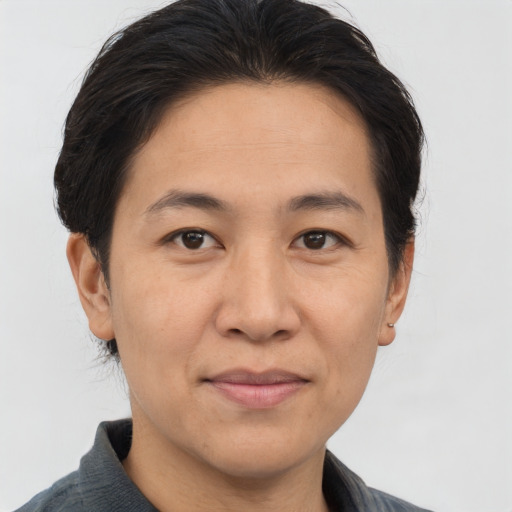 Joyful asian adult male with short  brown hair and brown eyes