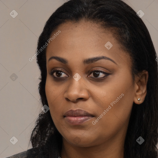 Joyful black young-adult female with long  black hair and brown eyes