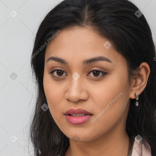 Joyful latino young-adult female with long  brown hair and brown eyes