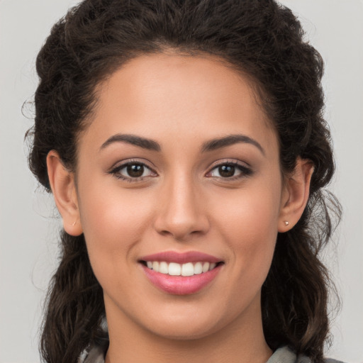 Joyful white young-adult female with long  brown hair and brown eyes