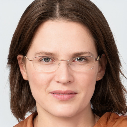 Joyful white adult female with medium  brown hair and grey eyes