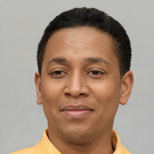 Joyful latino young-adult male with short  brown hair and brown eyes