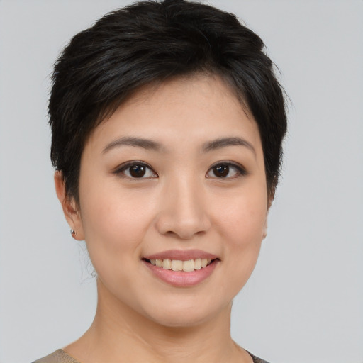Joyful asian young-adult female with short  black hair and brown eyes