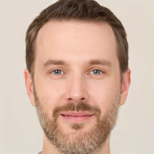 Joyful white adult male with short  brown hair and grey eyes