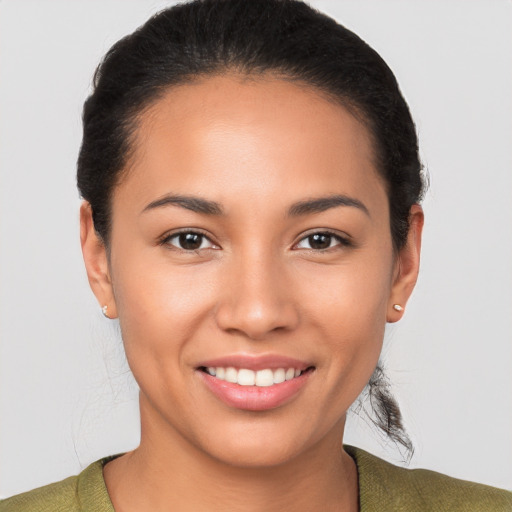 Joyful latino young-adult female with short  brown hair and brown eyes