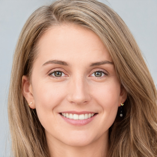 Joyful white young-adult female with long  brown hair and green eyes