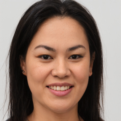 Joyful latino young-adult female with long  brown hair and brown eyes