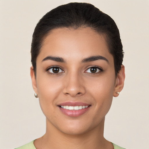 Joyful latino young-adult female with short  brown hair and brown eyes