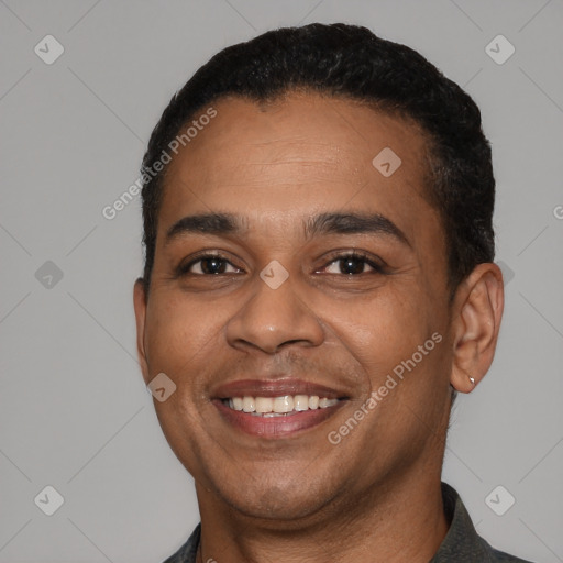 Joyful latino young-adult male with short  black hair and brown eyes