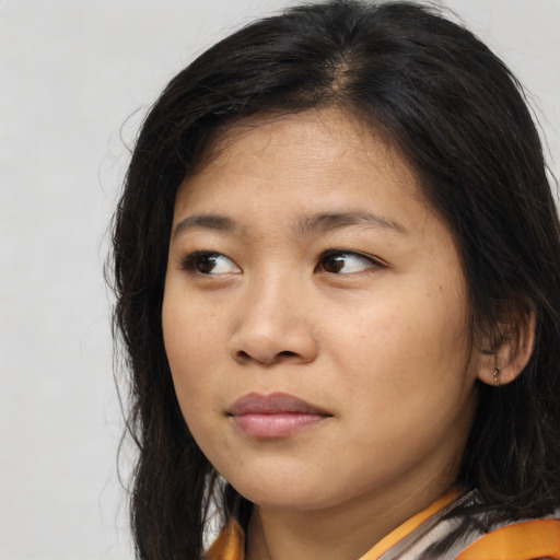 Joyful asian young-adult female with medium  brown hair and brown eyes
