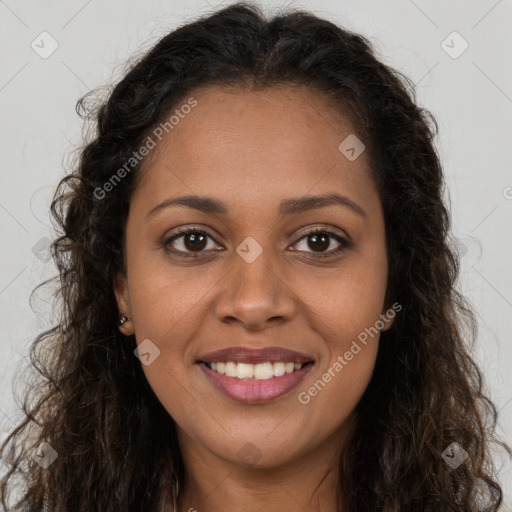 Joyful black young-adult female with long  brown hair and brown eyes