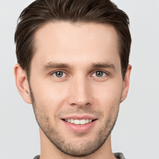 Joyful white young-adult male with short  brown hair and brown eyes