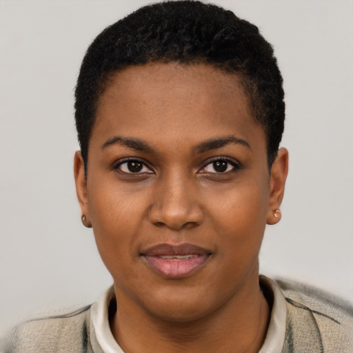 Joyful black young-adult female with short  black hair and brown eyes