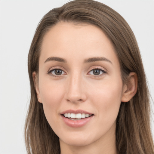 Joyful white young-adult female with long  brown hair and grey eyes