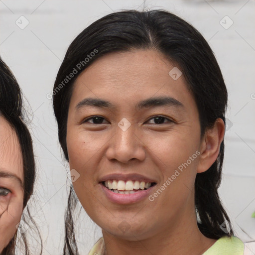 Joyful asian young-adult female with medium  brown hair and brown eyes