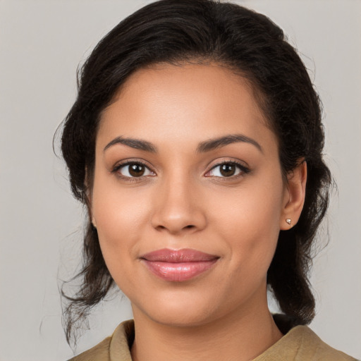 Joyful latino young-adult female with medium  brown hair and brown eyes