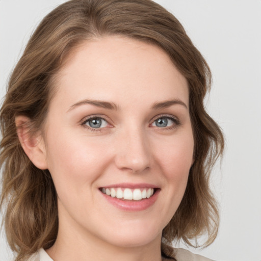 Joyful white young-adult female with medium  brown hair and green eyes