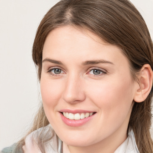 Joyful white young-adult female with medium  brown hair and blue eyes