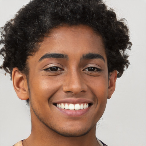 Joyful latino young-adult male with short  brown hair and brown eyes