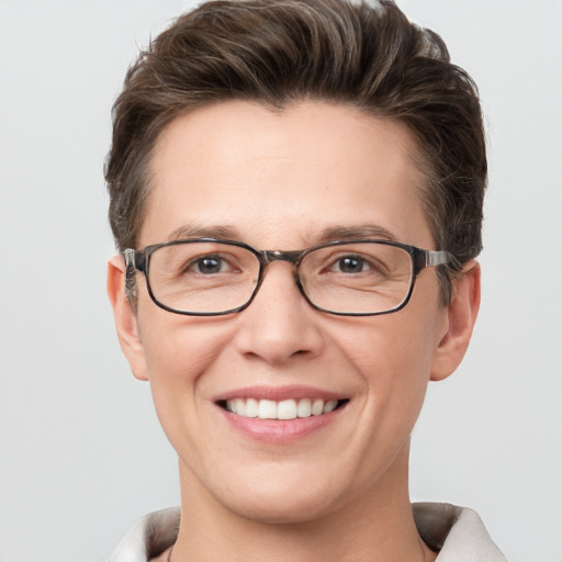 Joyful white adult female with short  brown hair and grey eyes