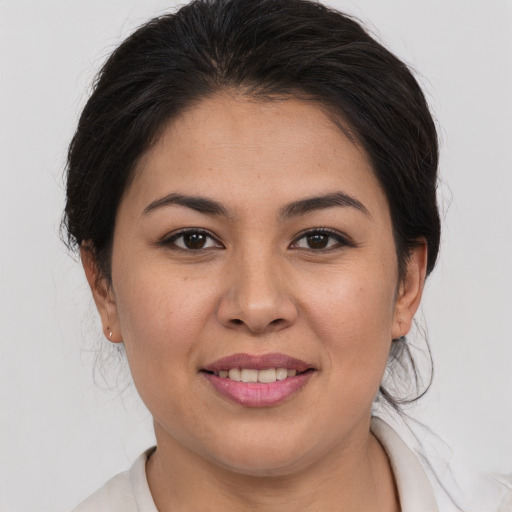 Joyful latino young-adult female with short  brown hair and brown eyes