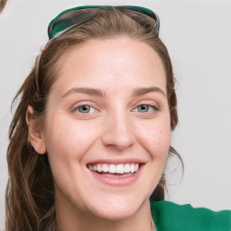 Joyful white young-adult female with long  brown hair and green eyes