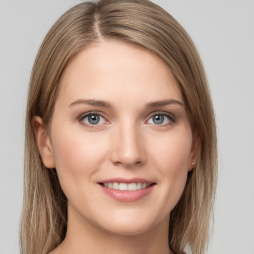 Joyful white young-adult female with long  brown hair and grey eyes