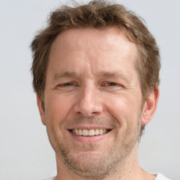 Joyful white adult male with short  brown hair and grey eyes