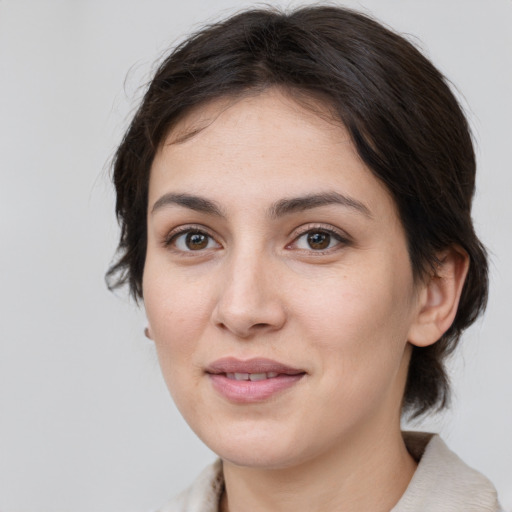 Joyful white young-adult female with medium  brown hair and brown eyes