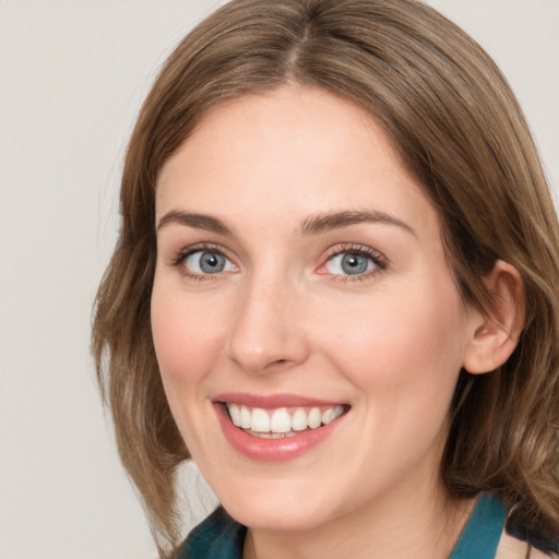 Joyful white young-adult female with medium  brown hair and blue eyes