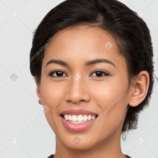 Joyful latino young-adult female with long  brown hair and brown eyes