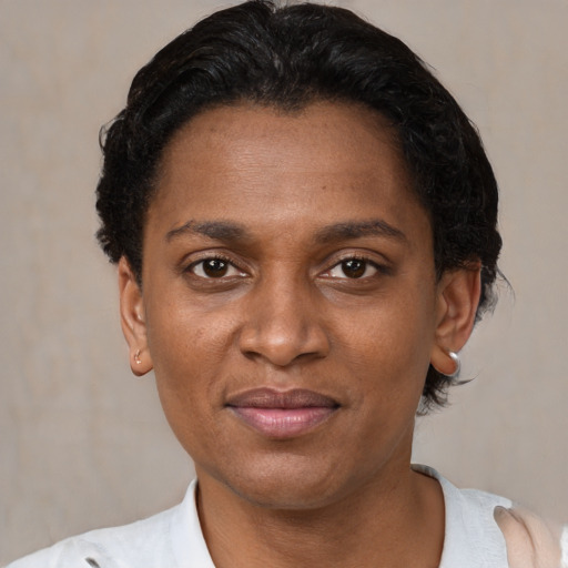 Joyful black adult female with short  brown hair and brown eyes