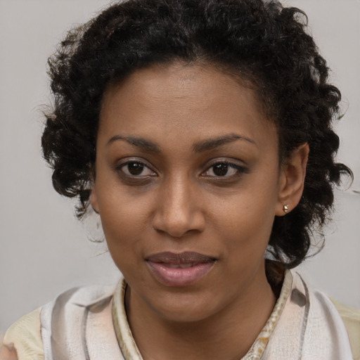 Joyful black young-adult female with short  brown hair and brown eyes
