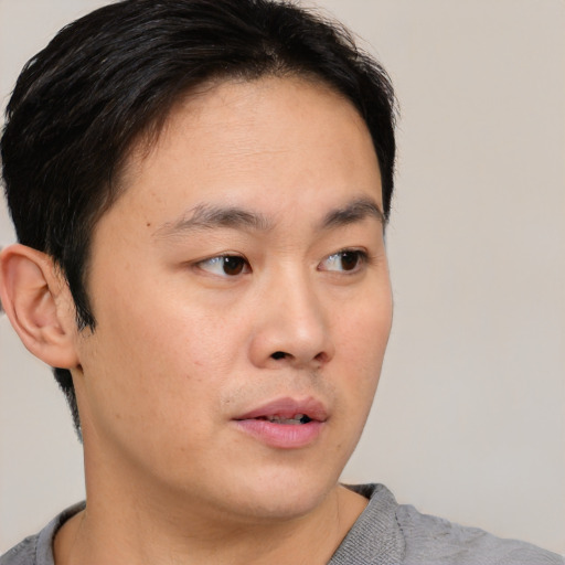 Neutral asian young-adult male with short  brown hair and brown eyes