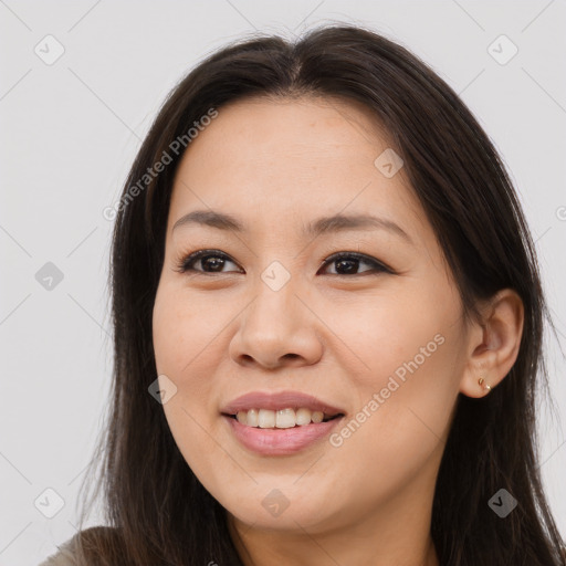 Joyful asian young-adult female with long  brown hair and brown eyes