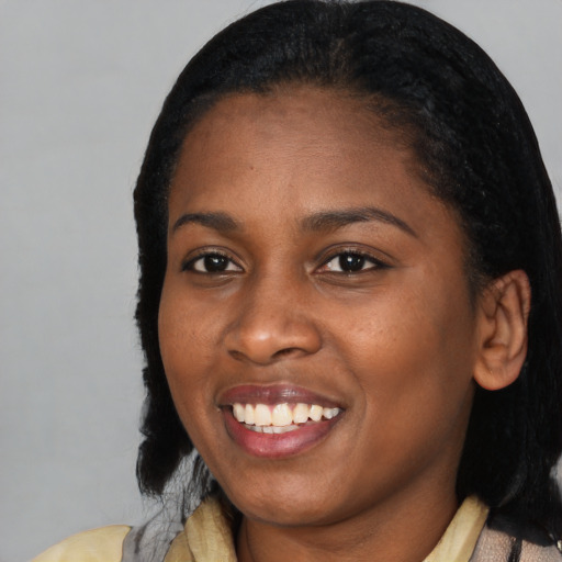 Joyful black young-adult female with medium  black hair and brown eyes