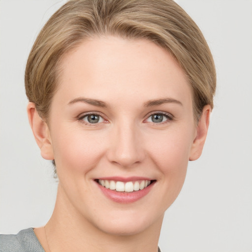 Joyful white young-adult female with short  brown hair and grey eyes