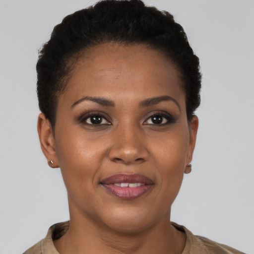 Joyful black young-adult female with short  brown hair and brown eyes
