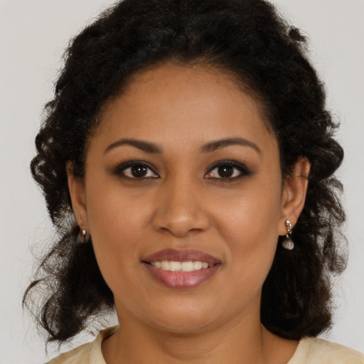 Joyful latino young-adult female with long  brown hair and brown eyes