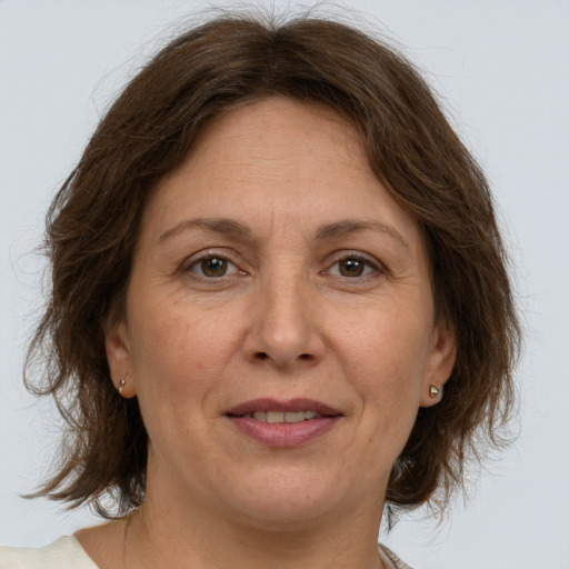 Joyful white adult female with medium  brown hair and brown eyes