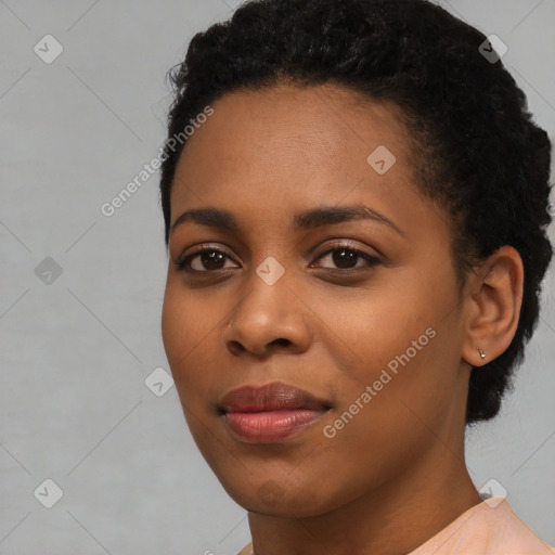 Joyful black young-adult female with short  black hair and brown eyes