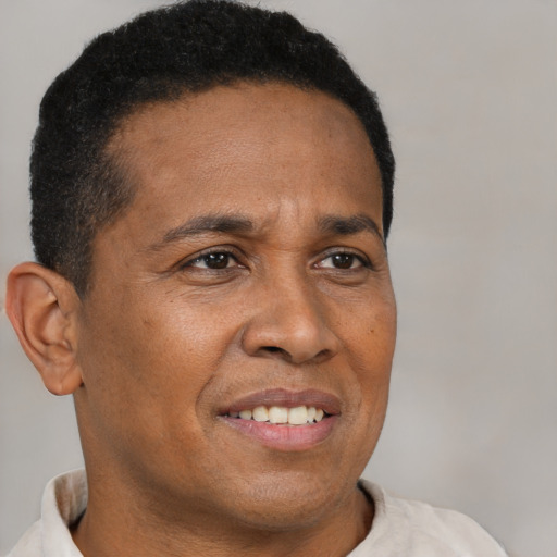 Joyful latino adult male with short  brown hair and brown eyes