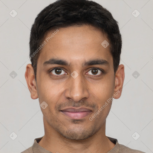 Joyful latino young-adult male with short  brown hair and brown eyes