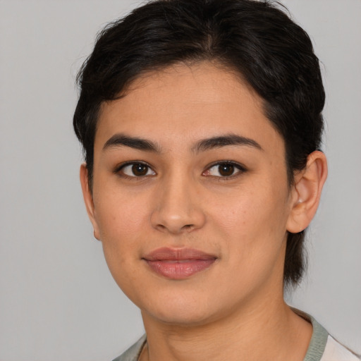 Joyful asian young-adult female with short  brown hair and brown eyes